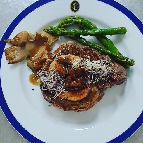 Filete de carne a la plancha con espárragos verdes y guarnición